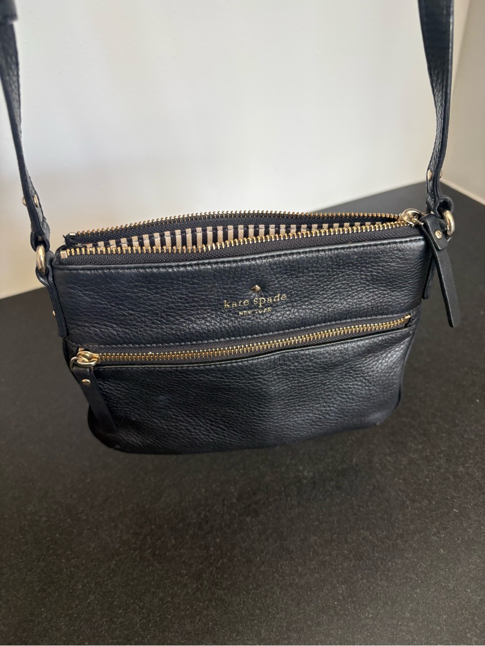kate spade black leather crossbody with gold hardware and striped interior